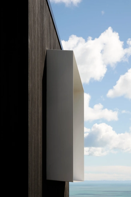 <img alt="Exterior cladding detail at Haumoko House — dark corrugated cladding with white box window frame, Site Architecture Clifton Christchurch." src="/images/2/5/1/0/2/251029lmhl044-dbc839fd.webp?description" width="1536" height="2048" />