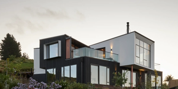 Haumoko House by Site Architecture. Two offset dark-clad volumes on Clifton hillside with timber plinth, Christchurch residential architecture.
