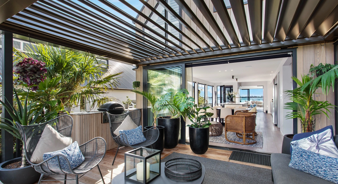 <img alt="Covered outdoor living area with louvred pergola, lush planting and views to the pool and coastal landscape." src="/images/d/o/n/-/r/don-roy-site-architecture-moncks-bay-deck-porch-area-chch-07a95f5b.webp?description" width="2560" height="1706" />