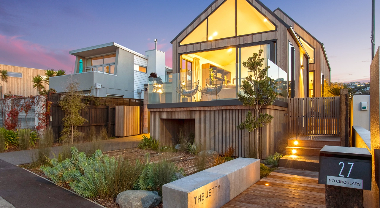 <img alt="Beachville at dusk, warm cedar volumes and contemporary gabled form with pool and deck glowing in the evening light." src="/images/d/o/n/-/r/don-roy-site-architecture-moncks-bay-street-front-05142f62.webp?description" width="2560" height="1707" />