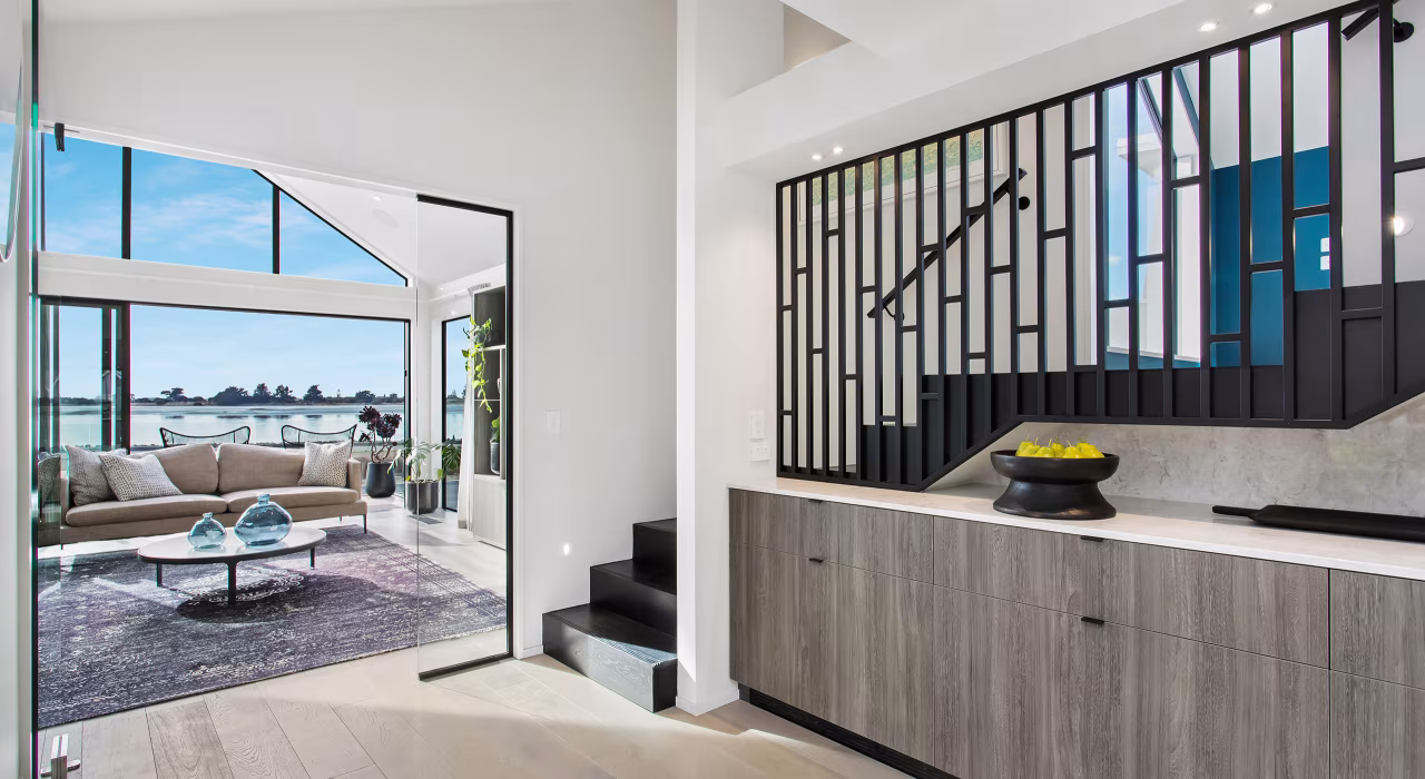 <img alt="Open staircase with dark balustrade, timber treads and view through to the coastal landscape." src="/images/d/o/n/-/r/don-roy-site-architecture-moncks-entrance-hallway-14623b09.webp" width="2560" height="1707" />