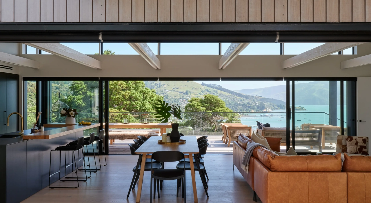 <img alt="Interior dining and living area at Akaroa Pentref. Open plan with timber joinery and harbour views, Site Architecture. " src="/images/i/n/t/e/r/interior-akaroa-pentref-site-architecture3-srp-d06c4651.webp?description" width="4000" height="3000" />