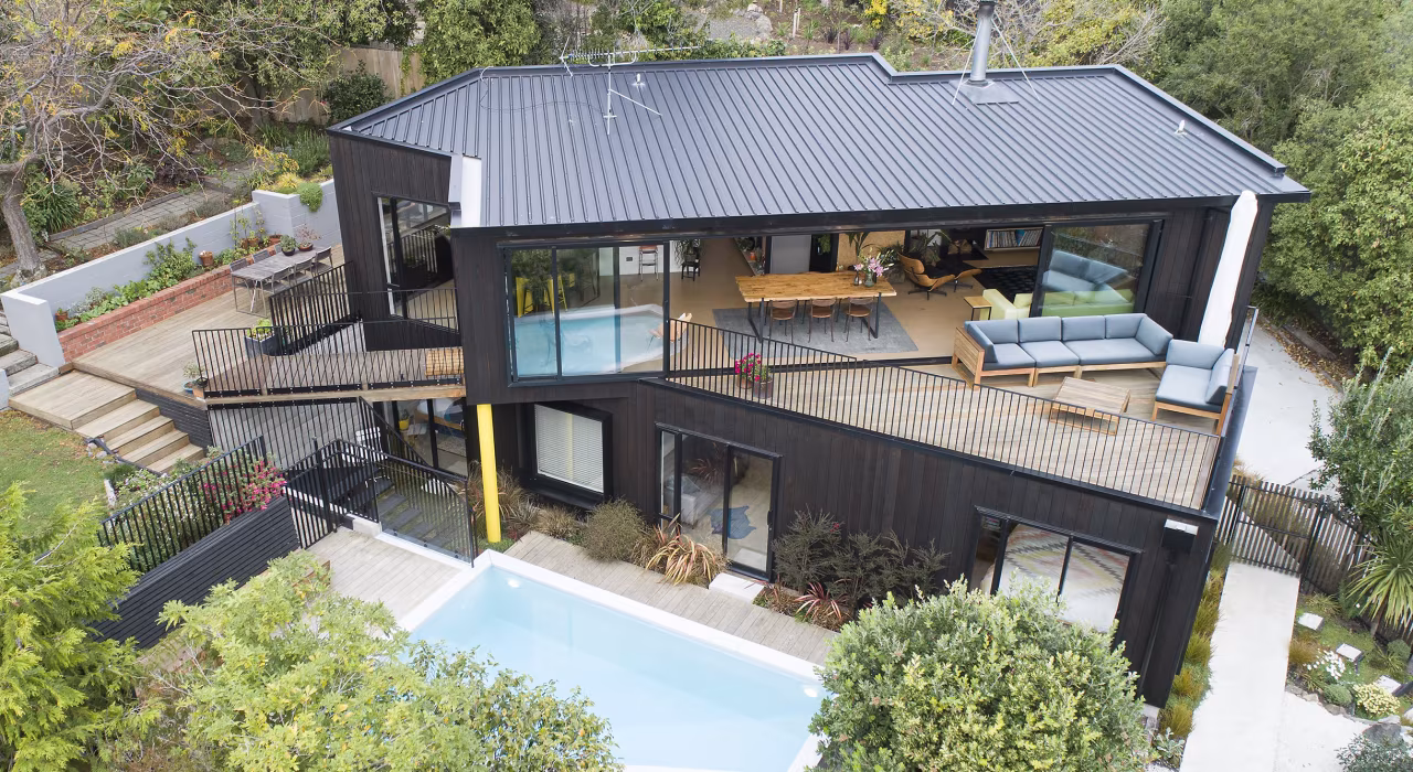 <img alt="Aerial view of Clementine's dark metal roof and stacked cedar volumes, with a pool and deck stepping down the hillside." src="/images/s/i/t/e/-/site-arch-clementine-st-andrews-hill-drone-shot2-5dc39993.webp" width="2440" height="1372" />