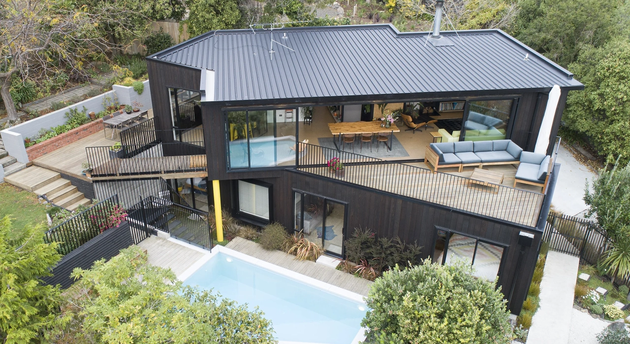 <img alt="Aerial view of Clementine's dark metal roof and stacked cedar volumes, with a pool and deck stepping down the hillside." src="/images/s/i/t/e/-/site-arch-clementine-st-andrews-hill-drone-shot2-503d7f6e.webp?description" width="2440" height="1372" />