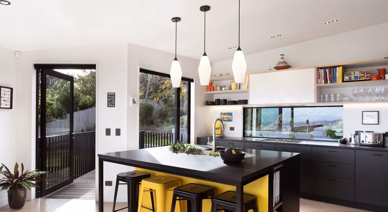 <img alt="Dining space with pendant lighting and dark joinery opening to an outdoor deck through full-height glazing." src="/images/s/i/t/e/-/site-arch-clementine-st-andrews-hill-kitchen-8a5c8f68.webp" width="2440" height="1627" />
