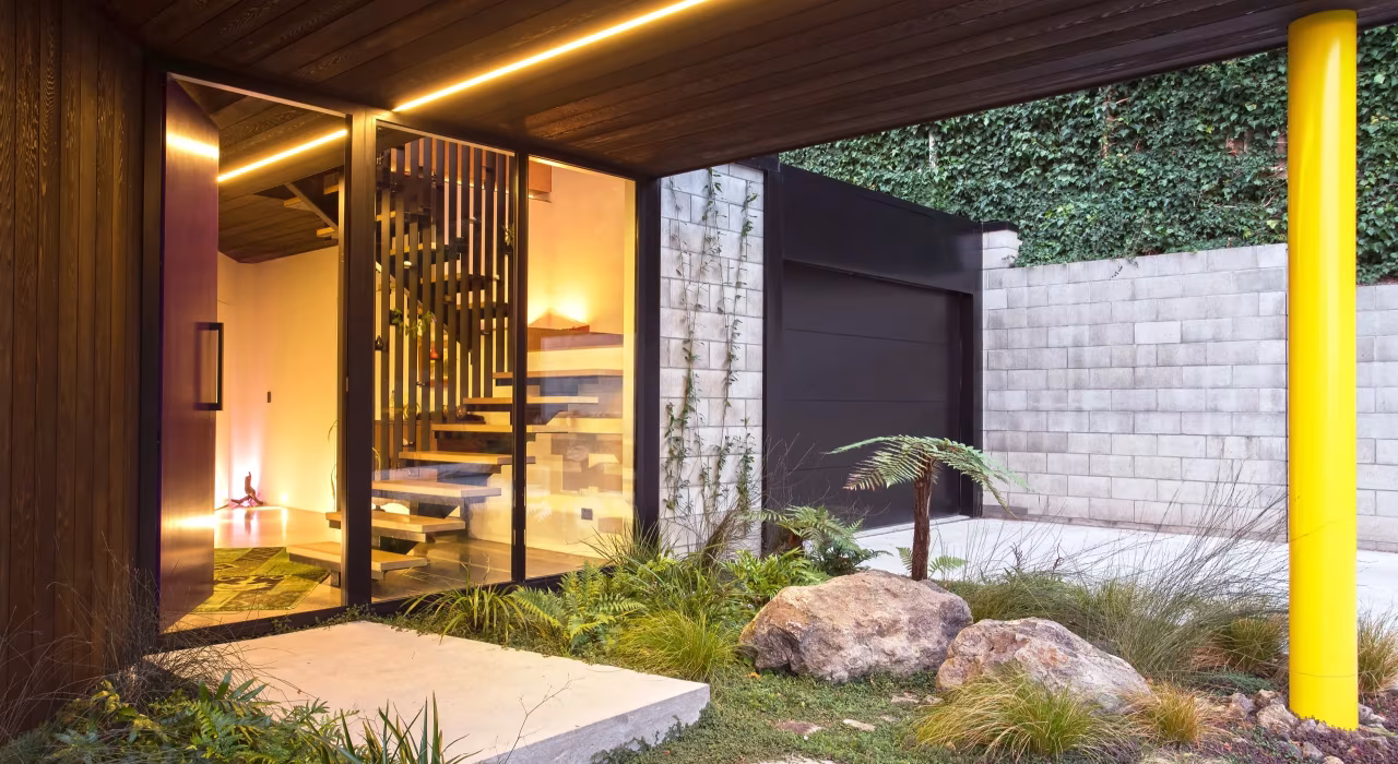 <img alt="Warm evening light at the entry of Clementine, dark cedar cladding meeting a concrete block wall with lush exterior planting." src="/images/s/i/t/e/-/site-arch-clementine-st-andrews-hill3-1f818ef6.webp" width="2560" height="1706" />