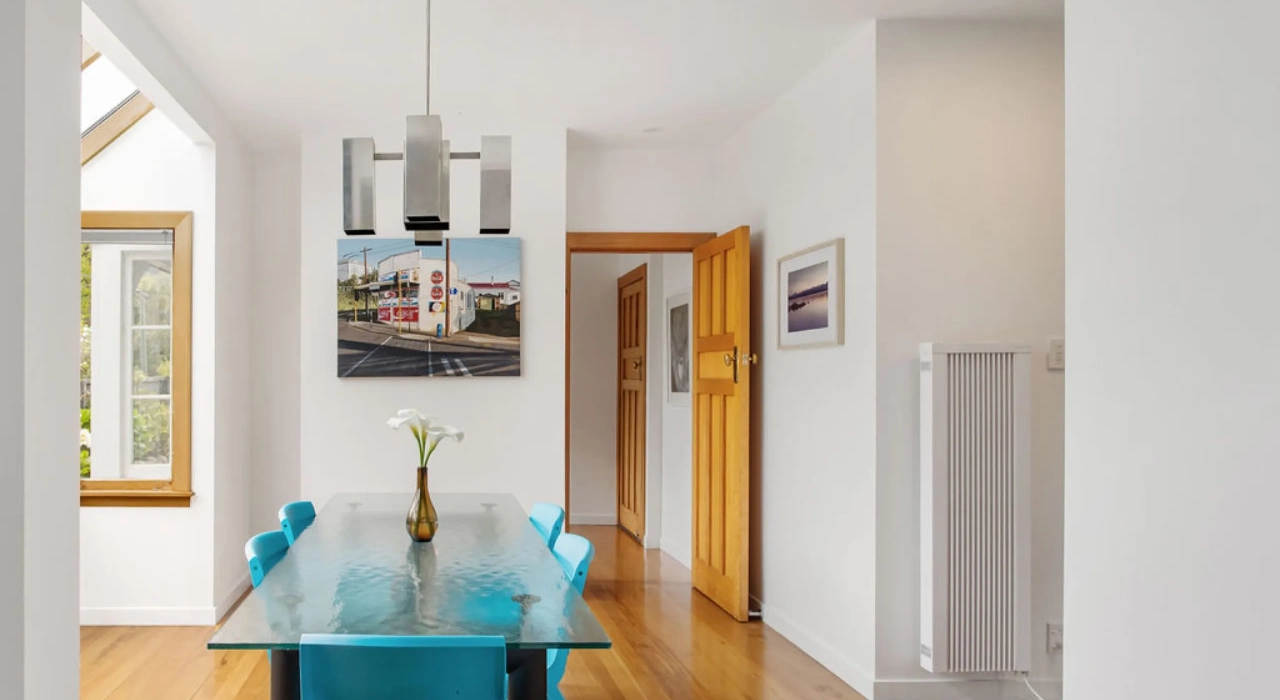 <img alt="Dining room with timber joinery, blue chairs and artwork, bright natural light from large windows." src="/images/s/i/t/e/-/site-arch-grange2-43eec071.webp?description" width="2560" height="1707" />