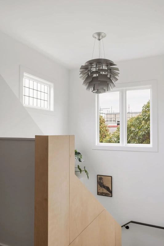 <img alt="Light-filled corner with white-framed windows, pendant light and a simple timber console, quietly connecting interior to the garden." src="/images/s/i/t/e/-/site-arch-grange5-e2307ed7.webp?description" width="1705" height="2560" />