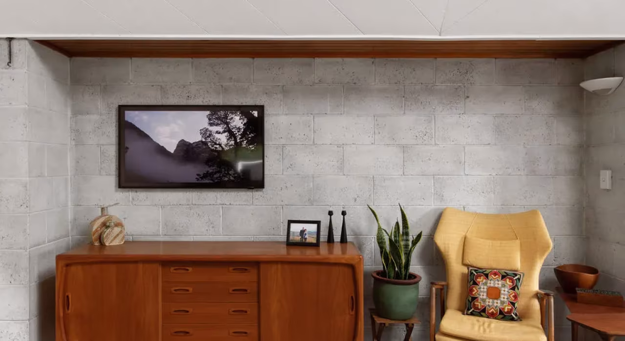 <img alt="Sitting area with timber sideboard, mid-century armchair and curated artwork, original Warren and Mahoney home, Christchurch." src="/images/s/i/t/e/-/site-arch-paulus-tce-7-5a85427d.webp" width="1024" height="683" />