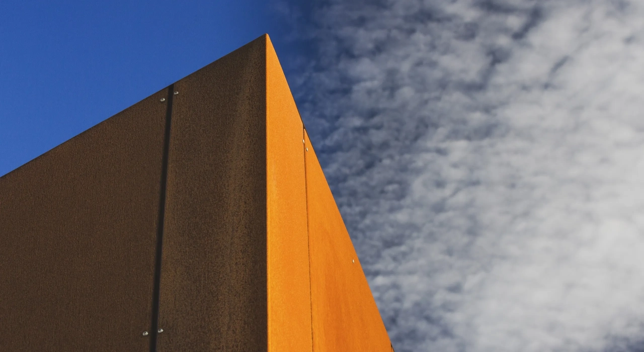 <img alt="Corten steel cladding detail against a dramatic sky, weathered surface catching the afternoon light." src="/images/s/i/t/e/-/site-architecture-drayton-drive3-655fddcf.webp?description" width="2560" height="1706" />