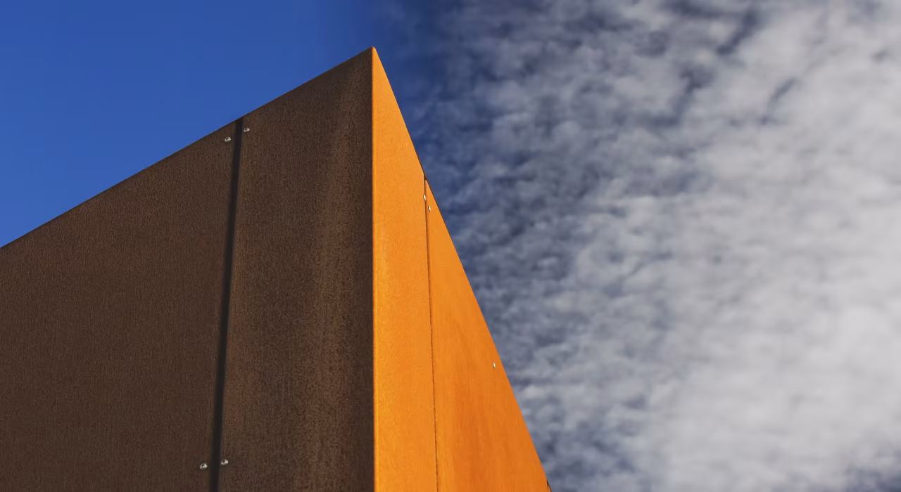 <img alt="Corten steel cladding detail against a dramatic sky, weathered surface catching the afternoon light." src="/images/s/i/t/e/-/site-architecture-drayton-drive3-905c3c2d.webp" width="2560" height="1706" />