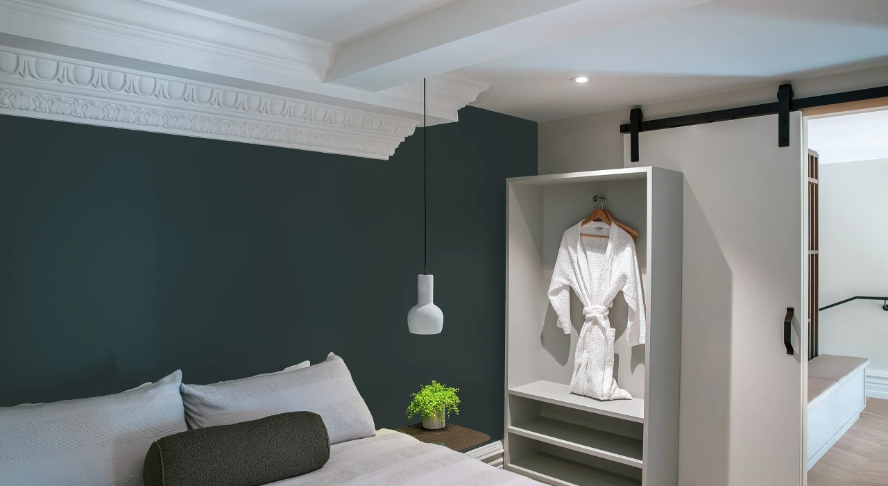 <img alt="Dark bedroom with soft wall lighting and artwork, a calm and considered retreat." src="/images/s/i/t/e/-/site-architecture-suite-17-ogb-interior-architecture8-8565ec5f.webp?description" width="2560" height="1707" />