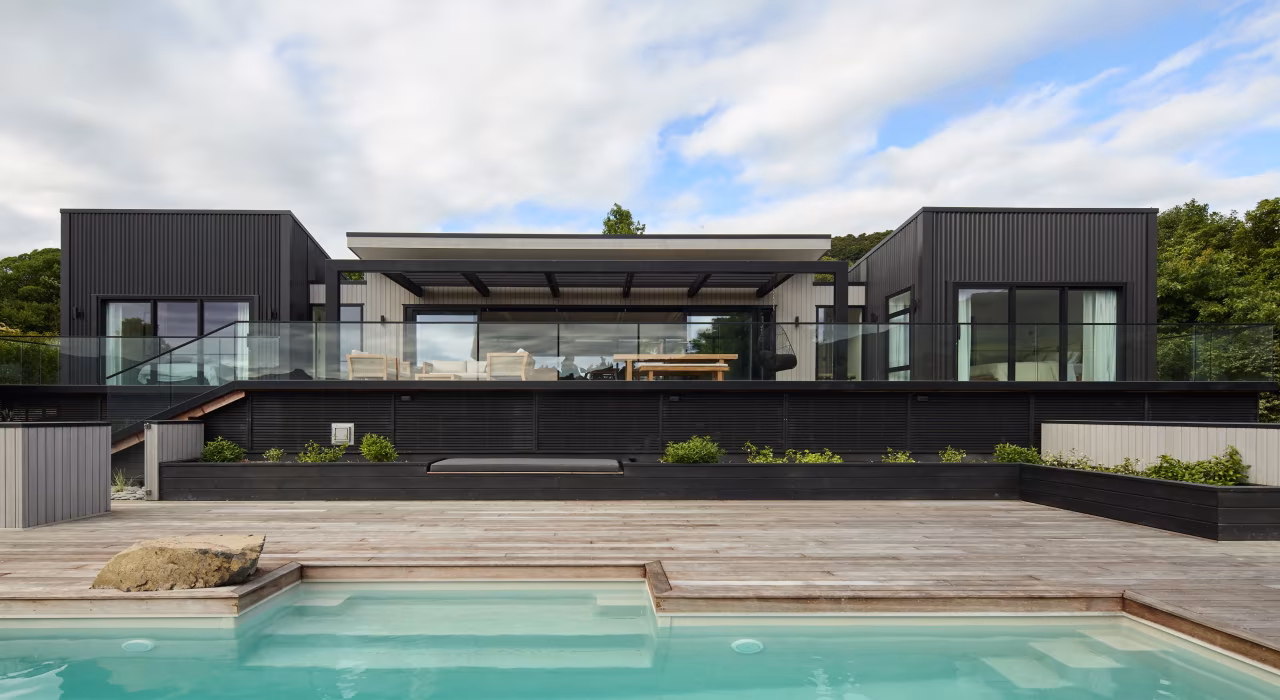 <img alt="South-west elevation and pool at Akaroa Pentref. Dark clad family home with pool above Akaroa Harbour, Site Architecture Christchurch." src="/images/s/o/u/t/h/south-west-elevation-2-akaroa-pentref-site-architecture-srp-5a5e682a.webp" width="4000" height="2667" />